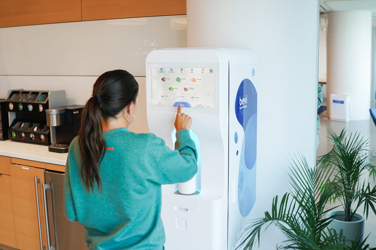 An office kitchen with a Bevi smart water system and a bean-to-cup coffee brewer
