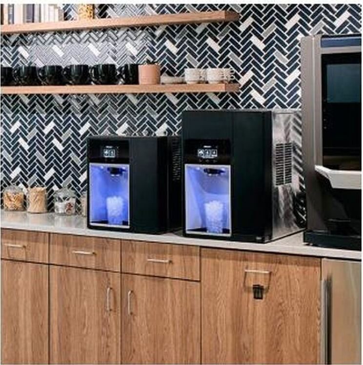 Two countertop ice and water dispensers in an office breakroom