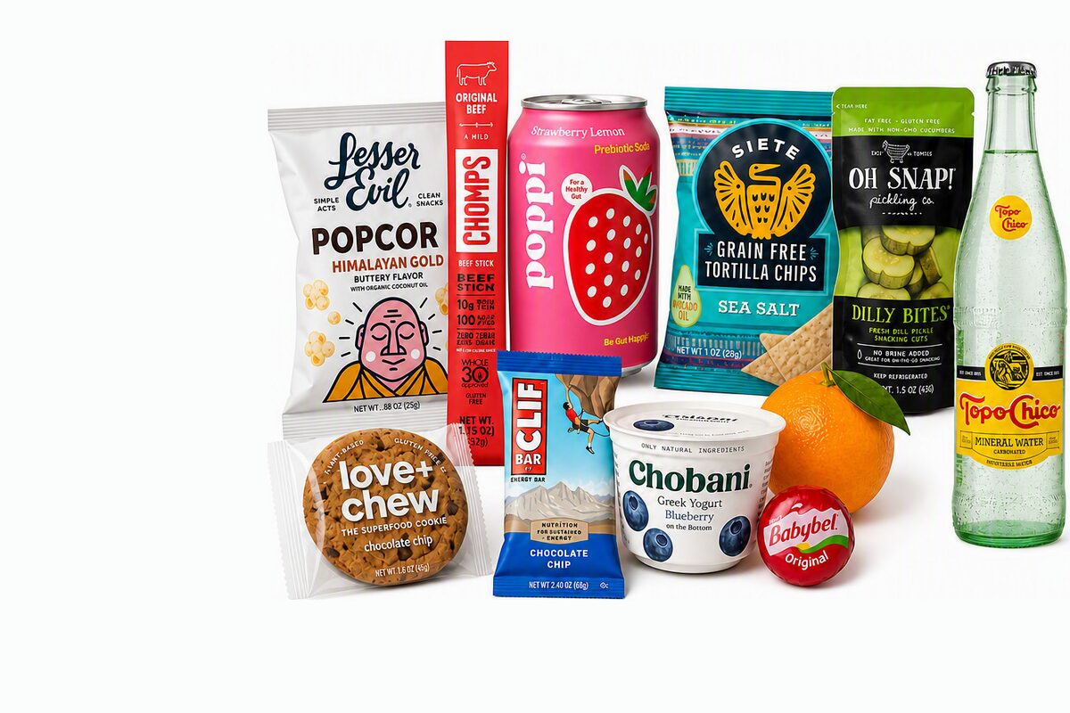 Office pantry snacks and drinks — popcorn, tortilla chips, protein bars, Greek yogurt, fruit, and sparkling water