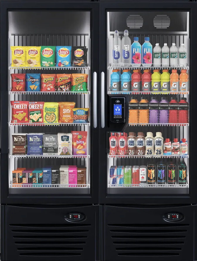 Double-door AI smart cooler stocked with chips, snack bars, bottled water, sports drinks, and protein shakes